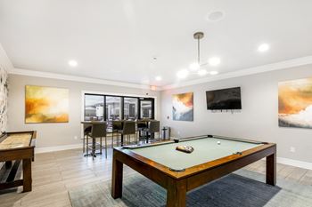 Gameroom with billiards and shuffle board at Crossgates Apartment Homes, Starkville, MS